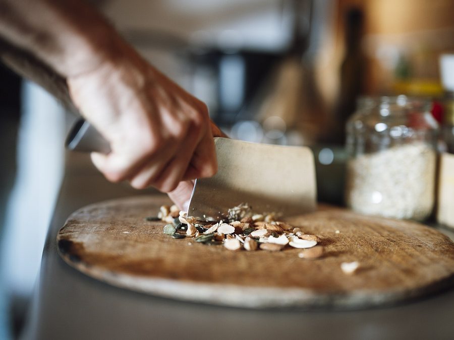 Hands preparing food together in the kitchen during a cooking session